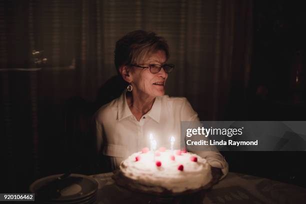 birthday celebration of an elderly woman - senior woman birthday stock pictures, royalty-free photos & images