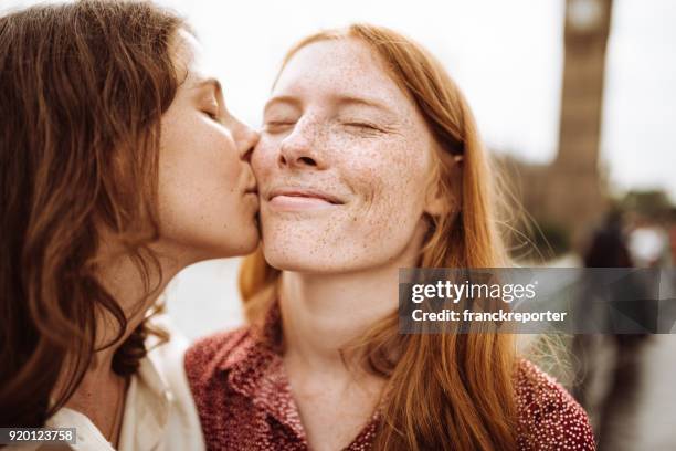 lesbian couple kissing at westminster bridge - photos of lesbians kissing stock pictures, royalty-free photos & images