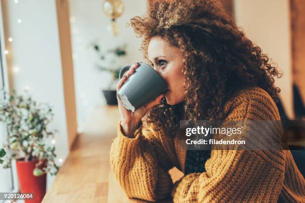 pretty woman at the cafe - mid adult woman sweater stock pictures, royalty-free photos & images