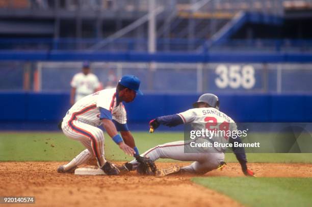 Willie Randolph of the New York Mets puts the tag on Deion Sanders of the Atlanta Braves during an MLB game on May 30, 1992 at Shea Stadium in...