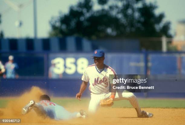 Rafael Santana of the New York Mets puts the tag on Tim Raines of the Montreal Expos during an MLB game on August 12, 1987 at Shea Stadium in...