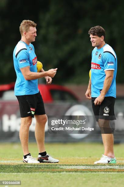 Magpies head coach Nathan Buckley speaks to his assistant Robert Harvey during a Collingwood Magpies AFL training session at the Holden Centre on...