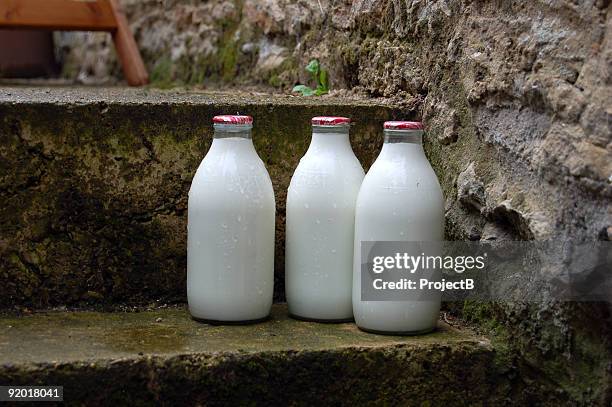 morning milk bottles on door step - mjölkflaska bildbanksfoton och bilder