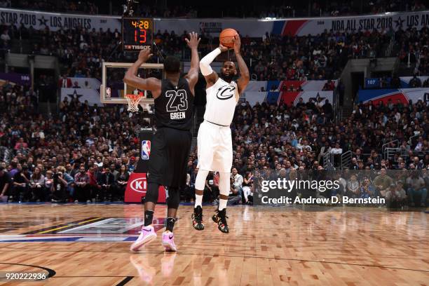 LeBron James Of Team LeBron shoots the ball against Draymond Green Of Team Stephen during the NBA All-Star Game as a part of 2018 NBA All-Star...