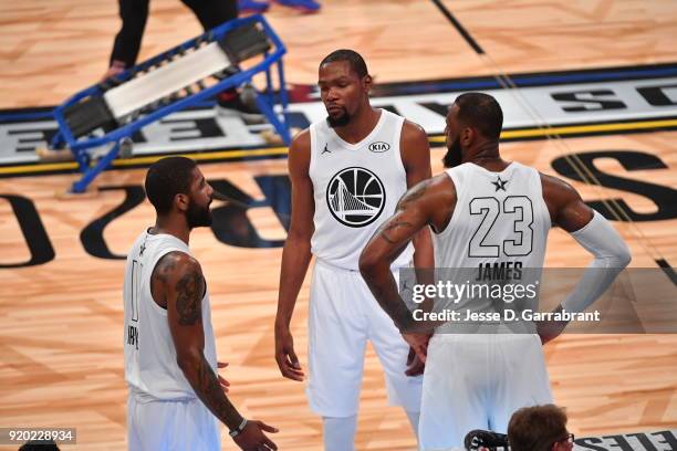 LeBron James, Kyrie Irving and Kevin Durant of Team LeBron all look on against Team Curry during the NBA All-Star Game as a part of 2018 NBA All-Star...