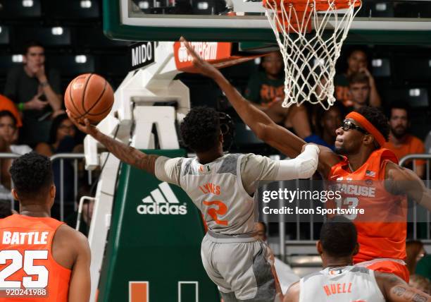 Miami guard Chris Lykes shoots against Syracuse center Paschal Chukwu during a college basketball game between the Syracuse University Orange and the...