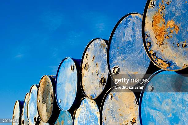 rusty metal barrels stacked in rows - toxic waste 個照片及圖片檔