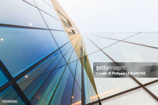 glass modern building against sky - built structure foto e immagini stock
