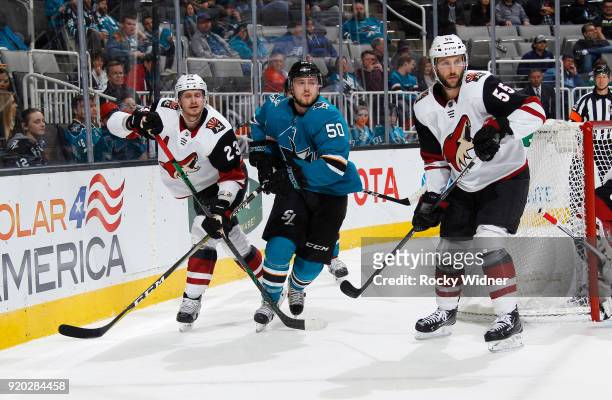 Chris Tierney of the San Jose Sharks skates against Oliver Ekman-Larsson and Jason Demers of the Arizona Coyotes at SAP Center on February 13, 2018...