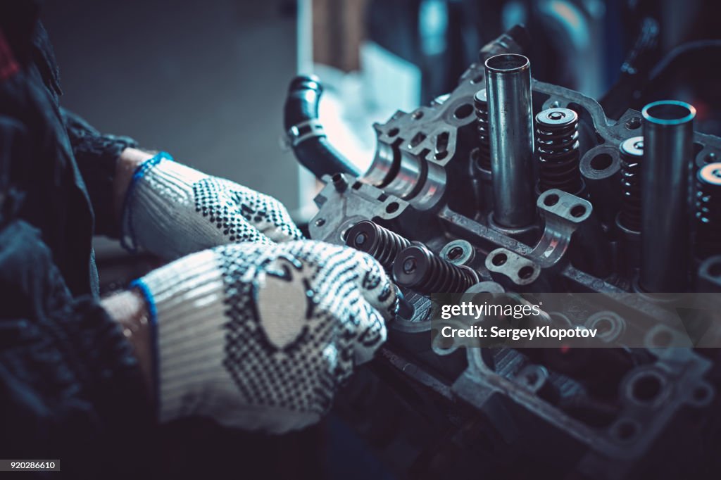 The auto mechanic deconstructs the internal combustion engine