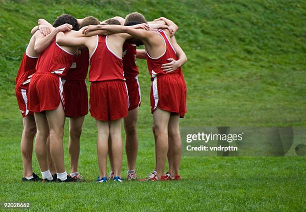 cross country pre-race huddle - running spikes stock pictures, royalty-free photos & images