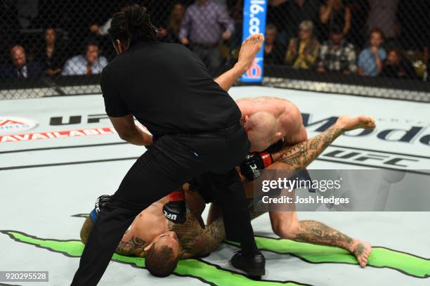 Referee Herb Dean stops Donald Cerrone from punching Yancy Medeiros in their welterweight bout during the UFC Fight Night event at Frank Erwin Center...