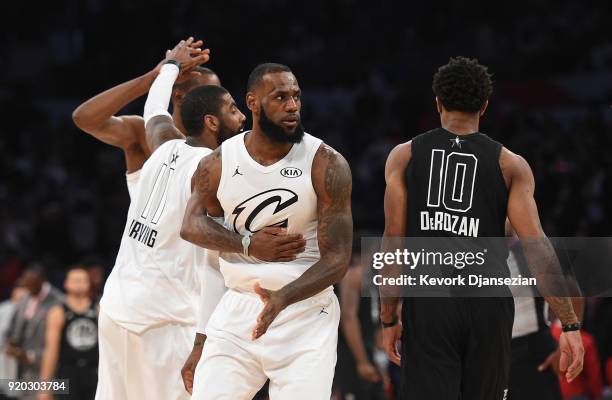 Kevin Durant, Kyrie Irving, LeBron James of Team LeBron celebrate as DeMar Derozan of Team Stephen looks on during the NBA All-Star Game 2018 at...