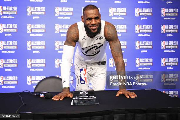 LeBron James of Team LeBron poses for a photo with the Most Valuable Player Trophy during a press conference after the NBA All-Star Game as a part of...