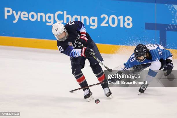 Hannah Brandt of the United States and Michelle Karvinen of Finland battle for the puck during the Ice Hockey Women Play-offs Semifinals on day 10 of...