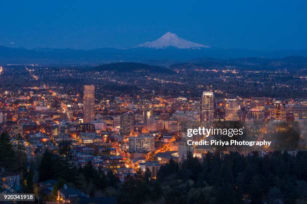 mount hood with downtown portland at dusk from pittock mansion - portland stock pictures, royalty-free photos & images