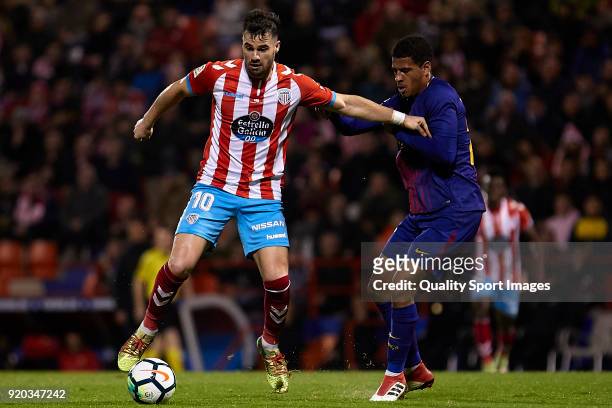 Antonio Campillo of CD Lugo is challenged by Marcus McGuane of FC Barcelona B during the La Liga 123 match between CD Lugo and FC Barcelona B at...