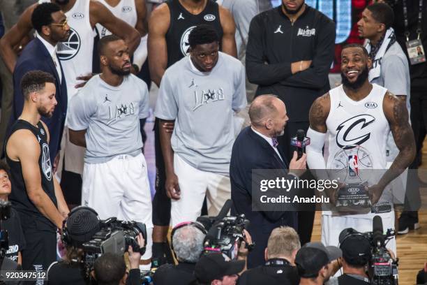 Stephen Curry of Team Stephen looks on as LeBron James of Team Lebron wins the MVP trophy after Team Lebron defeats Team Stephen during the 2018 NBA...