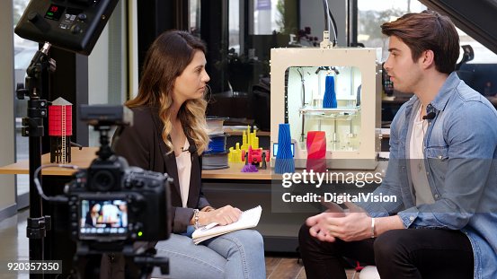 Reporter interviewing in a 3D printing office Reporter interviewing in a 3D printing office