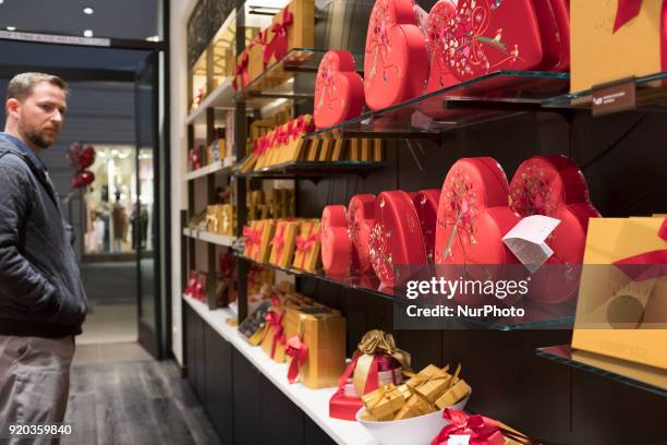 Man browsing chocolate products before Valentine's Day in a Godiva store in Stanford Shopping Center on February 13 Palo Alto, California.