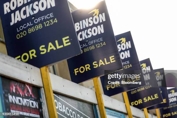 Robinson Jackson estate agency 'for sale' signs stand in the district of Catford in London, U.K., on Friday, Feb. 16, 2018. London's property market...