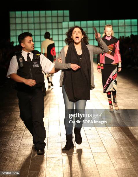 Woman seen protesting against the Fashion Week as models keep walking the runway at the Mary Katrantzou show during London Fashion Week February 2018...