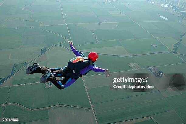 royalty free stock photo: woman skydiving - i can fly! - hoppa fallskärm bildbanksfoton och bilder