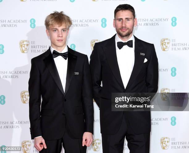 Tom Taylor and Edward Holcroft pose in the press room during the EE British Academy Film Awards held at the Royal Albert Hall on February 18, 2018 in...