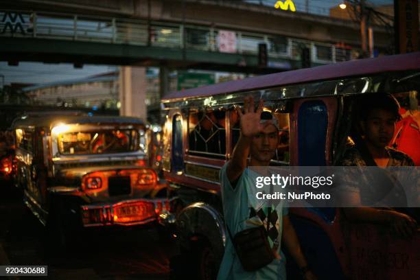Man raises his hand as he flags potential jeepney passengers in Manila, Philippines on Friday, February 3, 2018. The Jeepney has become a symbol of...