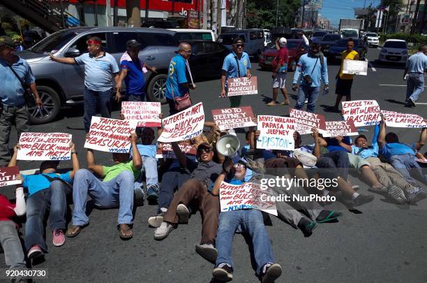 Jeepney drivers belonging to the activist jeepney driver group PISTON stage a 'die-in' during a protest against the Philippine government's jeepney...