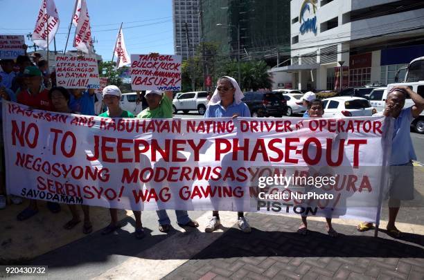 Jeepney drivers belonging to the activist jeepney driver group PISTON listen to a speech during a protest against the Philippine government's jeepney...