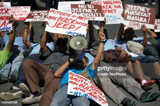Jeepney drivers belonging to the activist jeepney driver group PISTON stage a 'die-in' during a protest against the Philippine government's jeepney...
