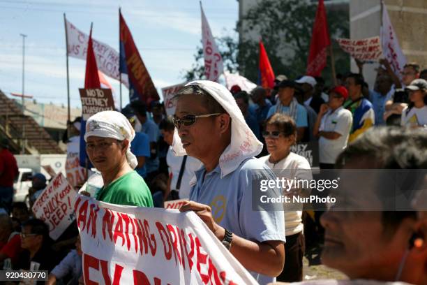 Jeepney drivers belonging to the activist jeepney driver group PISTON listen to a speech during a protest against the Philippine government's jeepney...