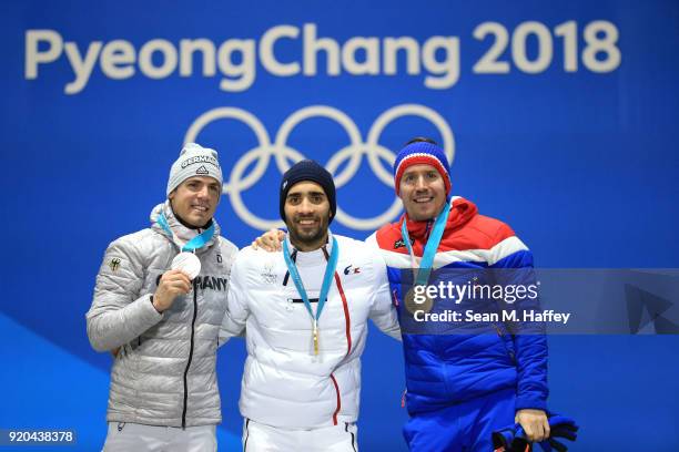 Silver medalist Simon Schempp of Germany, gold medalist Martin Fourcade of France and bronze medalist Emil Hegle Svendsen of Norway celebrate during...