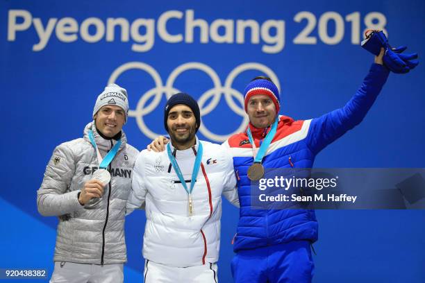 Silver medalist Simon Schempp of Germany, gold medalist Martin Fourcade of France and bronze medalist Emil Hegle Svendsen of Norway celebrate during...