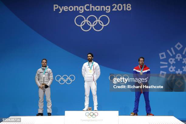 Silver medalist Simon Schempp of Germany, gold medalist Martin Fourcade of France and bronze medalist Emil Hegle Svendsen of Norway stand on the...