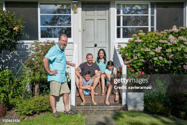 smiling family on steps outside house - portrait of young woman standing against steps imagens e fotografias de stock