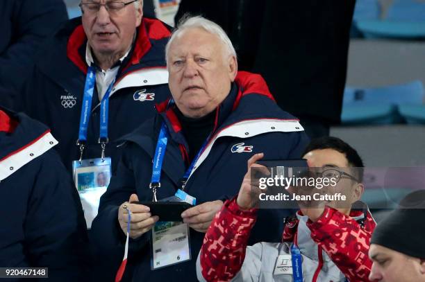 Alain Calmat celebrates the gold medal of Martin Fourcade of France during the victory ceremony in Men's 15km Mass Start on day nine of the...