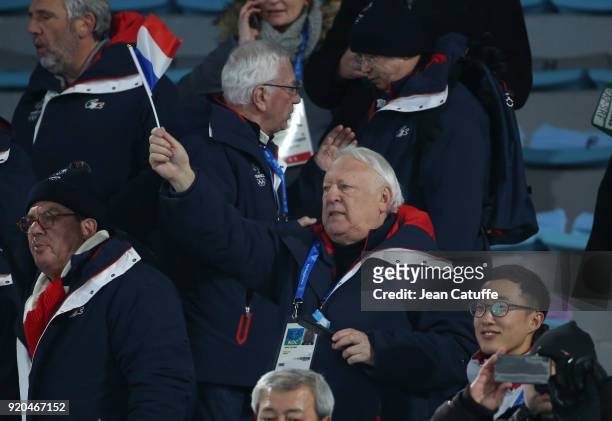 Alain Calmat celebrates the gold medal of Martin Fourcade of France during the victory ceremony in Men's 15km Mass Start on day nine of the...