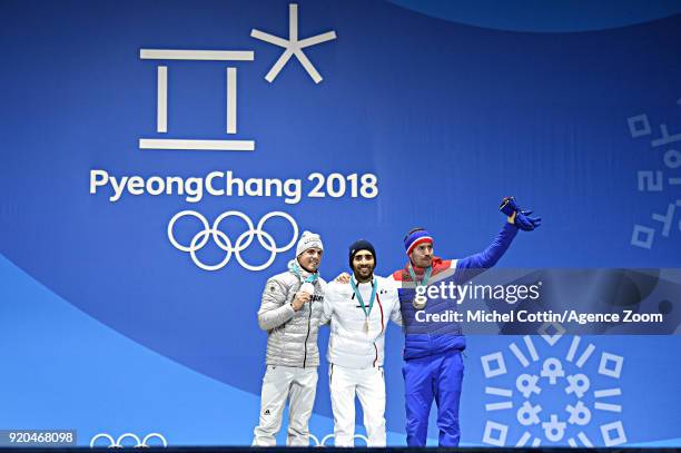 Simon Schempp of Germany wins the silver medal, Simon Fourcade of France wins the gold medal, Emil Hegle Svendsen of Norway wins the bronze medal...