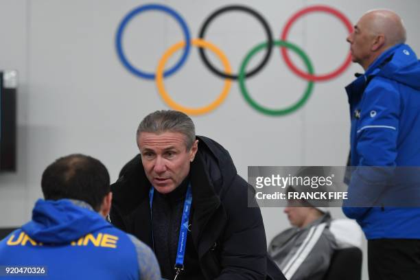 International Olympic Committee member and former Ukrainian pole vaulter Sergey Bubka speaks to a member of the Ukrainian Olympic team backstage at...