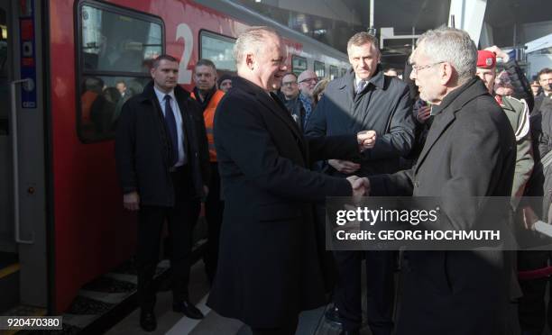 Austria's President Alexander van der Bellen welcomes Slovakia's President Andrej Kiska at the main railway station prior to a meeting in Vienna,...
