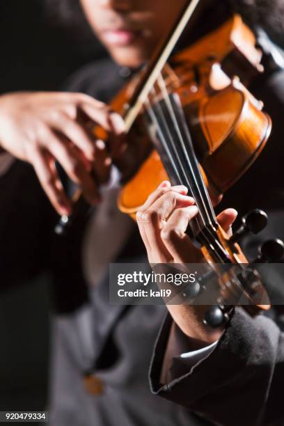 mixed race teenage boy playing the violin - classical music stock pictures, royalty-free photos & images