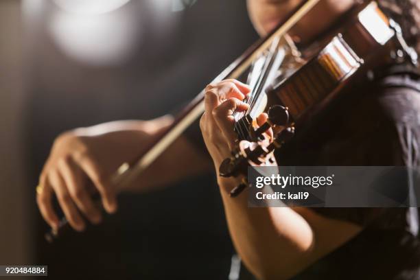 mixed race teenage girl playing the violin - musical instrument close up stock pictures, royalty-free photos & images