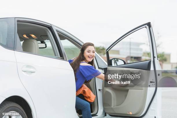 teenage girl, passenger looking out car door - open car door stock pictures, royalty-free photos & images