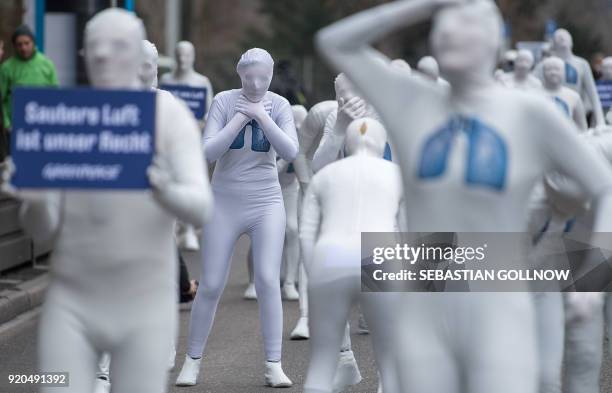 Greenpeace activists wear white morphsuits with lungs painted on them as they stage an action against particulate matter and health burden caused by...