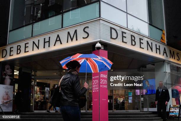 Shoppers pass a branch of the Debenhams chain of department stores on Oxford Street on February 19, 2018 in London, England. Debenhams has announced...