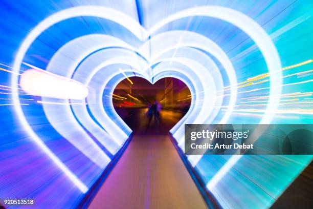 creative picture with zoom technique of illuminated hearts creating tunnel effect with light trails. - zoom date stock pictures, royalty-free photos & images