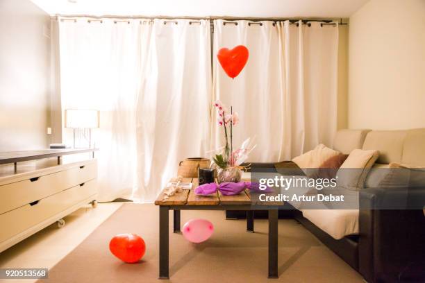 romantic picture of a helium red balloon with heart shape flying in the home during valentine's day. - valentine's day home stock pictures, royalty-free photos & images