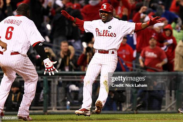 Jimmy Rollins and Ryan Howard of the Philadelphia Phillies celebrate after Rollins hit a game-winning 2-run double in the bottom of the ninth inning...